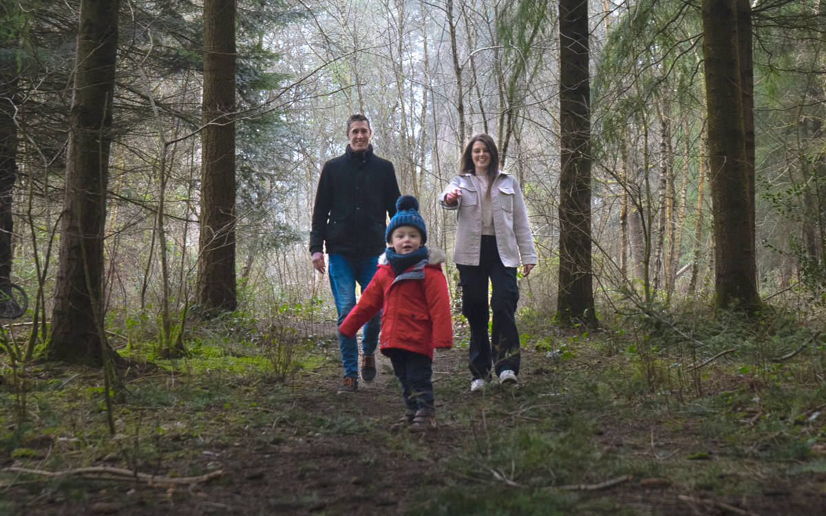 A family walking in woodland in Shropshire