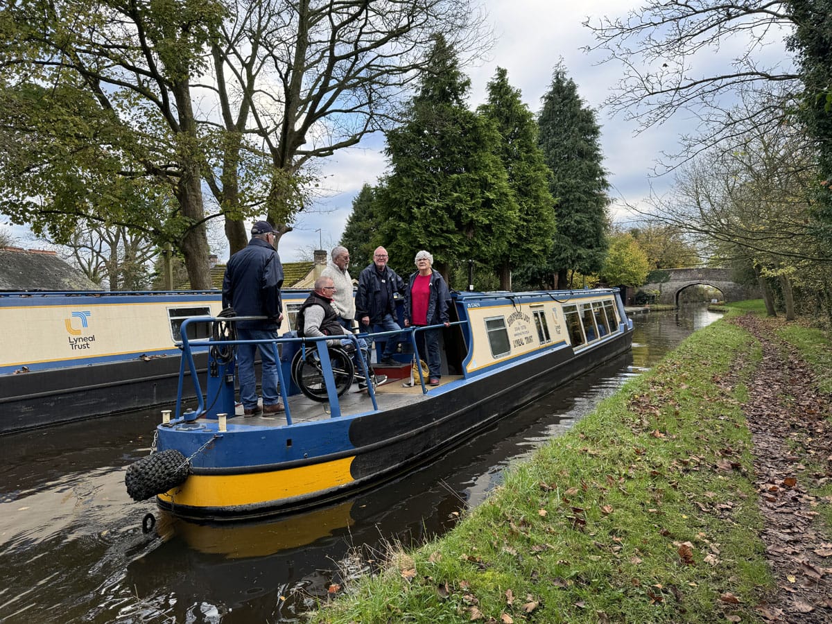A group of people aboard a narrowboat on a Shropshire canal