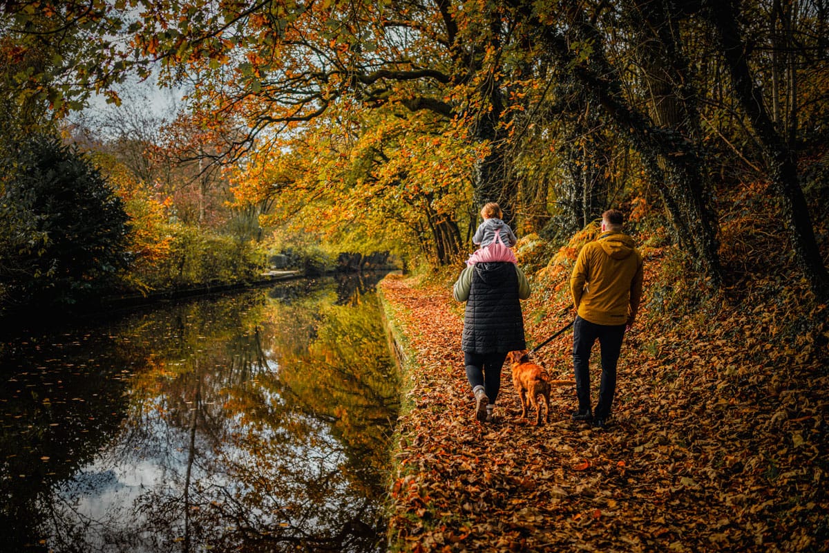 Couple and dog walking next to canal near ellesmere