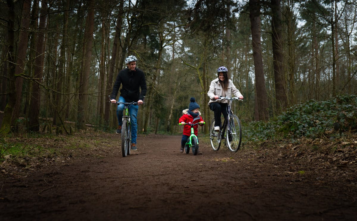 A family on a cycle ride in the woods