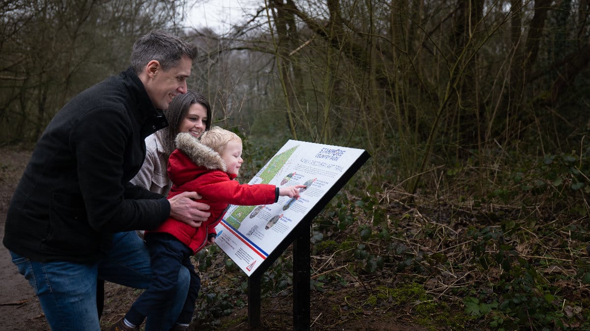 Family looking at the Family art trail sign