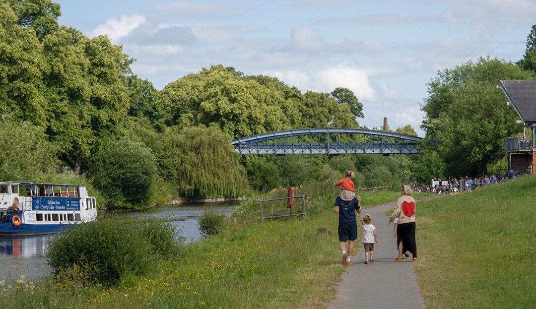 Family walking along the River Severn in Shewsbury