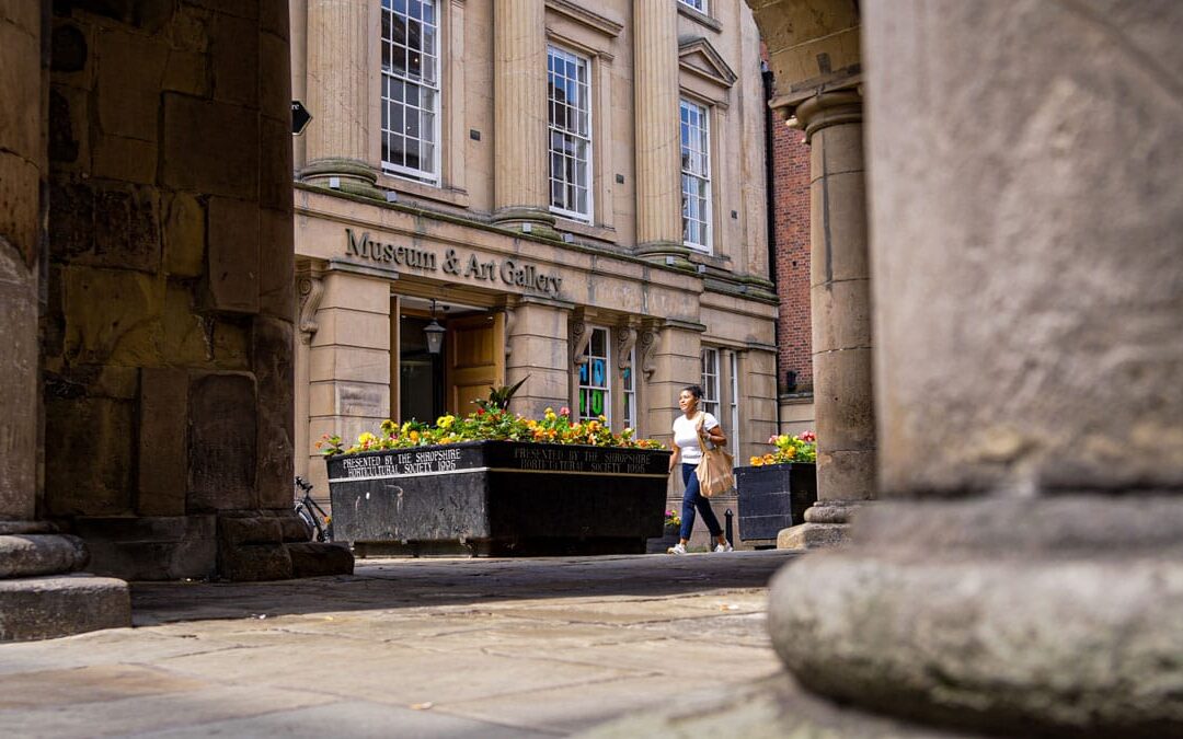 person walking by Shrewsbury Museum and Art gallery