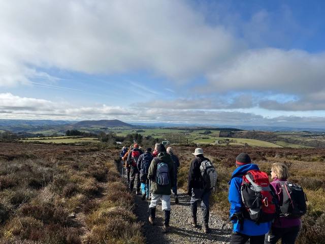 Group of walkers On Stiperstones ridge walking towards The Bog