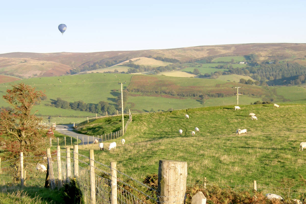 A hot air balloon flying over the Shropshire countryside