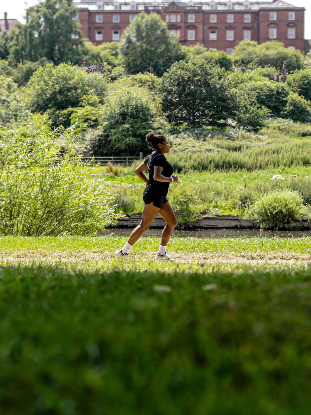 A person running in a green space in Shrewsbury