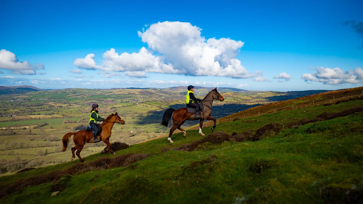 Two riders on horseback in the Shropshire countryside