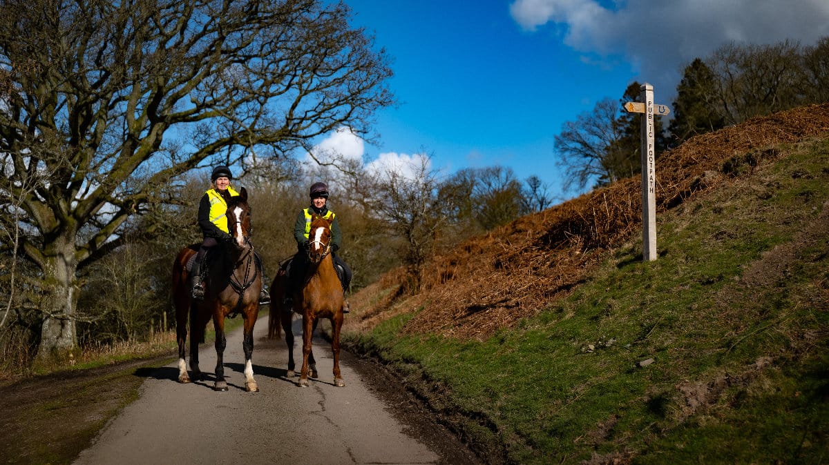 Two riders on horseback on a bridleway in Shropshire