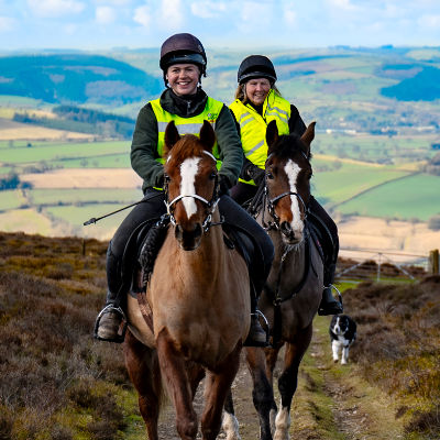 Two riders on horseback in the Shropshire countryside