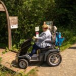 Lady on mobility scooter arriving at Mamouth tower at Whixall Moss
