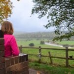 Lady sat on a bench looking at the view