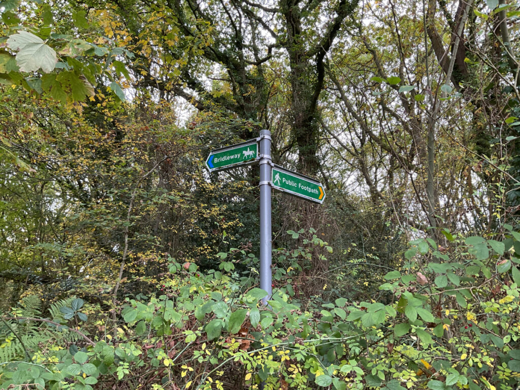 Photo of a finger post at Poles Coppice Car Park marking routes as Bridleway or Public Footpath.