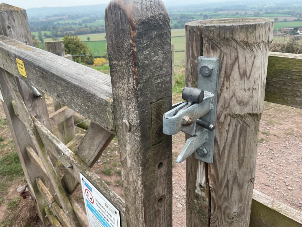Photo of a latched gate next to the toposcope at Lyth Hill from one side showing a sliding latch.