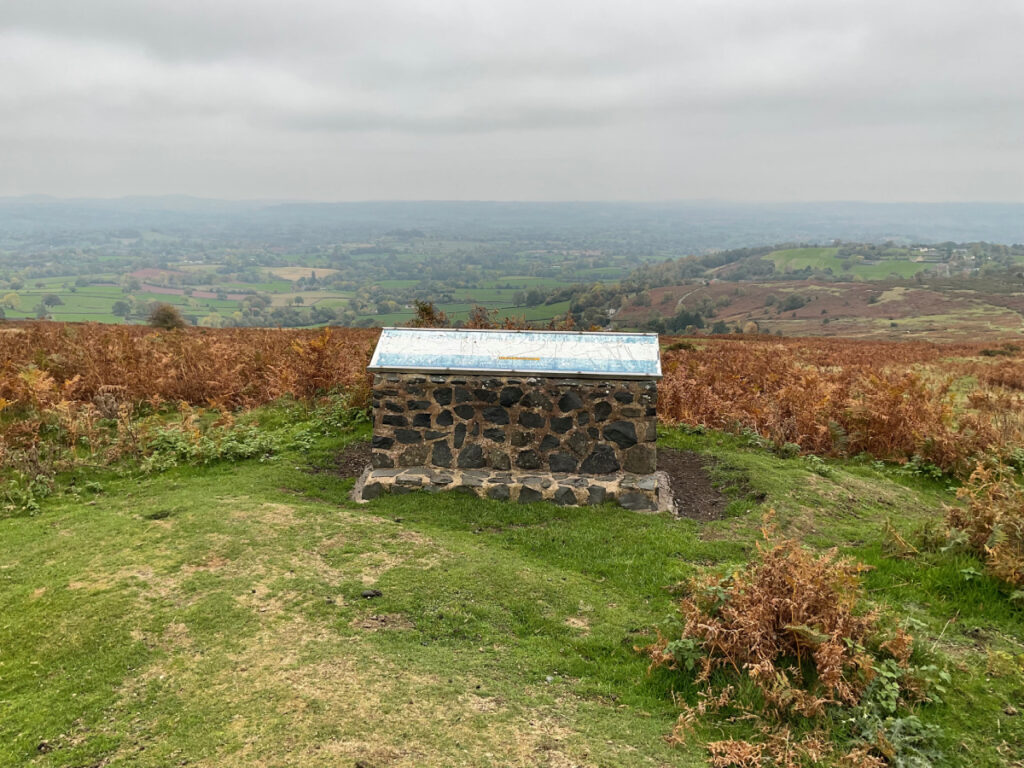 Photo capturing the toposcope at clee hill with a beautiful view behind it.