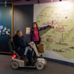 2 people looking at a map in the discovery centre, Craven Arms