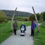 3 people on the Onny meadows trail - one on a mobility scooter
