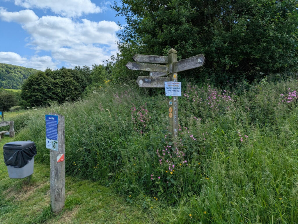 Picture of a fingerpost on the Onny Meadows behind Shropshire Hills Discovery Centre building.