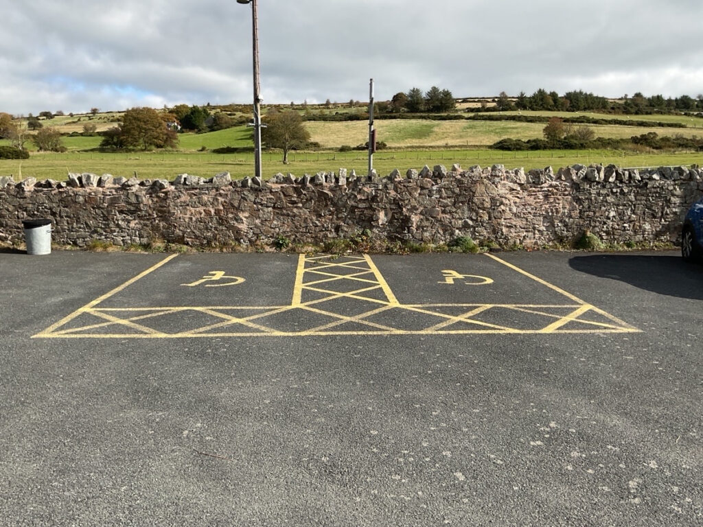 Picture showing two dedicated blue badge parking spots at the bog visitor centre.