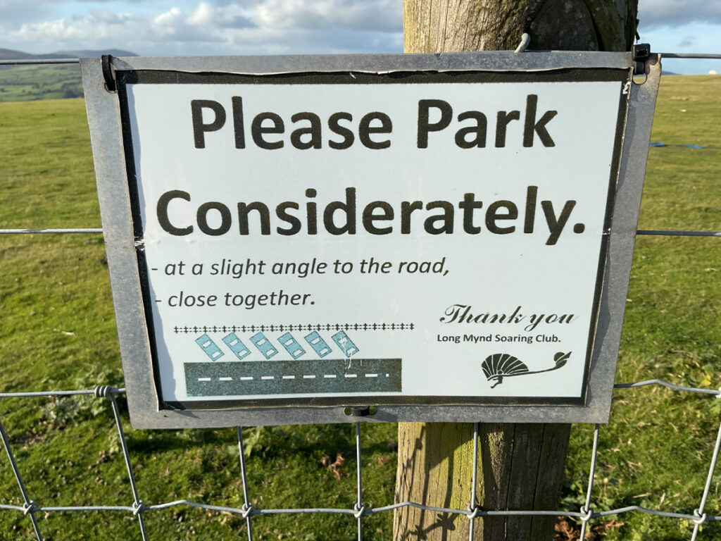 Photo of a sign at the car park asking drivers to park considerately.