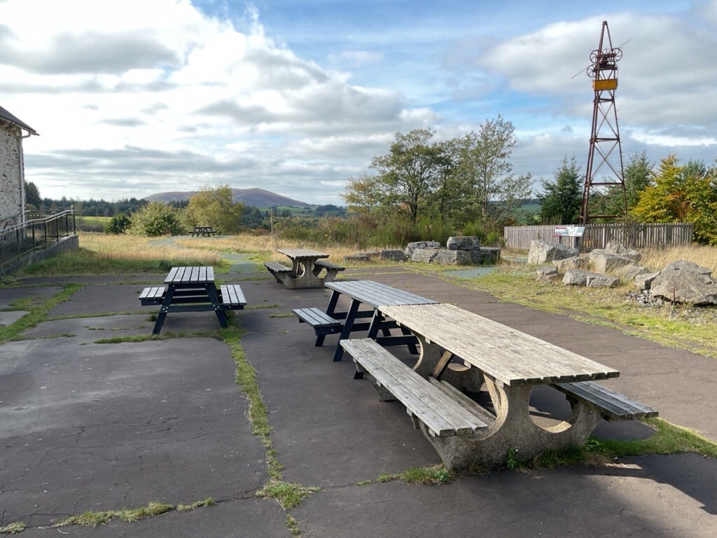 Picture showing outdoor picnic table and benches at The Bog Visitor Centre.