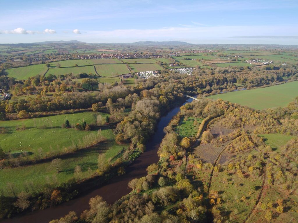 Aerial view over the river Severn, The village of Highley and beyond that, the Clee Hills can be seen.